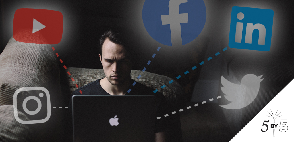 man on laptop with social logos