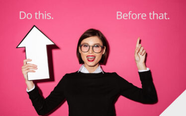 business woman pointing to "do this" sign with arrow and "before that" sign with finger