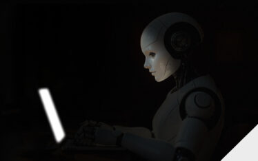 Robot in front of a laptop with a glowing screen